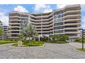 Luxury condominium complex featuring multi-story architecture, private balconies, and lush landscaping at 545 Sanctuary Dr # B806, Longboat Key, FL 34228