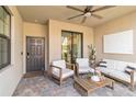 Charming covered patio features comfortable seating and a ceiling fan for outdoor relaxation at 5664 Palmer Cir # 102, Bradenton, FL 34211