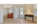 Welcoming foyer with tile flooring, complemented by an elegant entry door with glass detailing at 5934 Guarino Dr, Sarasota, FL 34238