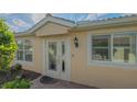 Inviting front entryway with glass-paneled door and sidelight, enhancing curb appeal and natural light at 5934 Guarino Dr, Sarasota, FL 34238