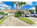Townhome complex featuring well-manicured lawns, palm trees, and ample parking at 7507 Preserves Ct # 7507, Sarasota, FL 34243