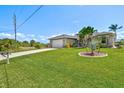 Well-kept lawn and lush landscaping enhance the curb appeal of this attractive home at 8058 Santa Cruz Dr, Port Charlotte, FL 33981