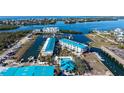 This aerial shot showcases the condo community, pool, and nearby waterways at 8222 Harborside Cir, Englewood, FL 34224