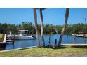 Waterfront property with a private dock, boat and clear blue water at 8731 Peggy Ave, Sarasota, FL 34231