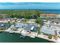 Aerial view of waterfront home with screened patio and boat dock on canal, easy access to bay at 10003 Sandpiper E Rd, Bradenton, FL 34209