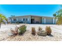The home has a clean exterior, natural rock landscaping, and an attached garage at 10003 Sandpiper E Rd, Bradenton, FL 34209