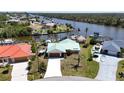 Aerial view of the home and neighborhood, showcasing mature landscaping and a private boat dock at 10616 Ayear Rd, Port Charlotte, FL 33981
