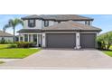Beautiful two-story home with a three-car garage and well-manicured landscaping at 11435 Apple Tree Cir, Bradenton, FL 34211