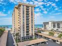 Exterior view of condo building close to the beach and parking spaces at 1212 Benjamin Franklin Dr # 708, Sarasota, FL 34236