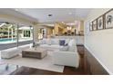 Bright living room with open floor plan, seamless access to screened pool, and modern furnishings at 1248 Northport Dr, Sarasota, FL 34242
