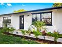 Inviting front door with decorative glass and manicured landscaping at 1311 Cypress Ave, Venice, FL 34285