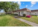 Charming home with a walkway, lush lawn, and colorful landscaping enhancing its appeal at 1343 Glendale W Cir # 216, Sarasota, FL 34232