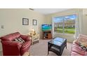 Cozy living space with a large window, plush seating, and a welcoming ambiance at 1343 Glendale W Cir # 216, Sarasota, FL 34232