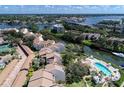 An aerial view of waterfront condos, a pool, boat docks, and views of the area at 1500 Cove Ii Pl # 524, Sarasota, FL 34242