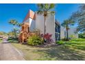 Well maintained condo building with manicured landscaping and bright blue sky at 1500 Cove Ii Pl # 524, Sarasota, FL 34242