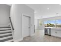 Bright entryway featuring a staircase and an open layout leading into the kitchen area at 1620 Sea Haven Dr # 404, Punta Gorda, FL 33950