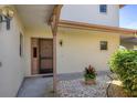 Inviting entrance way surrounded by rock and lush foliage at 1759 Lake Pl # 1759-B, Venice, FL 34293