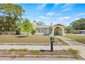 Charming home with light green paint, chimney, front porch, and a well-maintained lawn on a sunny day at 2102 7Th W Ave, Bradenton, FL 34205