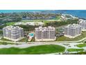 Expansive aerial shot of beachfront condos overlooking lush golf course and serene ocean waters at 3030 Grand Bay Blvd # 323, Longboat Key, FL 34228