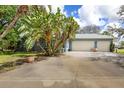 Spacious two-car garage with ample parking space and surrounding green landscape at 361 Whitfield Ave, Sarasota, FL 34243