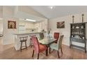 Cozy dining area with a glass table and kitchen counter seating, perfect for casual meals and entertaining at 4017 Crockers Lake Blvd # 1421, Sarasota, FL 34238