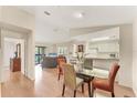 Bright dining room with a glass table, opening to a living area with a gray couch and sliding glass doors at 4017 Crockers Lake Blvd # 1421, Sarasota, FL 34238