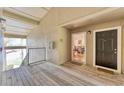 Inviting condo entrance with a wood porch, leading into a bright, airy space with views of the dining area at 4017 Crockers Lake Blvd # 1421, Sarasota, FL 34238