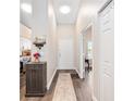 Bright foyer with wood-look floors, leading to a well-lit living space and modern kitchen at 4264 Central Sarasota Pkwy # 125, Sarasota, FL 34238