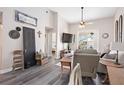 Inviting living room with a TV, fan and stylish decor, with an open view to the balcony at 4264 Central Sarasota Pkwy # 125, Sarasota, FL 34238