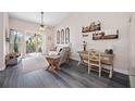 Cozy living room with a ceiling fan, desk area, and sliding doors to the balcony at 4264 Central Sarasota Pkwy # 125, Sarasota, FL 34238