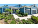 Inviting home exterior with a covered porch, lush landscaping, and a well-maintained walkway at 4308 Fly Rod Ter, Parrish, FL 34219