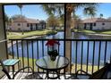 Relaxing screened balcony with a view of the lake, complete with a table and chairs for outdoor enjoyment at 4325 46Th W Ave # 202, Bradenton, FL 34210