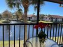 Relaxing screened balcony with a view of the lake, complete with a table and chairs for outdoor enjoyment at 4325 46Th W Ave # 202, Bradenton, FL 34210