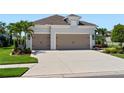 Charming home featuring a spacious three-car garage and meticulously maintained landscaping at 4625 Foxtail Dr, Parrish, FL 34219