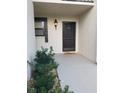 Inviting front door entrance with a well-lit porch and neatly maintained landscaping at 5630 Golf Pointe Dr # 108, Sarasota, FL 34243