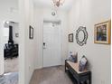 Inviting entryway features a bench, decorative mirror, and artwork, creating a warm welcome at 5727 Oak Bridge Ct, Bradenton, FL 34211