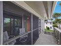 Relaxing screened patio featuring comfortable seating, tiled floor and view of exterior of the property at 6500 Flotilla Dr # 125, Holmes Beach, FL 34217