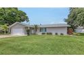 Attractive single-story home with a well-kept lawn, attached garage, and charming curb appeal at 755 Taplow Rd, Venice, FL 34293