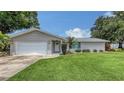 Well-manicured front yard of single story home with attached garage featuring a freshly painted exterior at 755 Taplow Rd, Venice, FL 34293