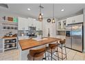Well-lit kitchen featuring a spacious wood island, stainless steel appliances, and ample cabinet space at 867 Bacon Ave, Sarasota, FL 34232