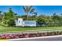 Welcoming entrance to Tideline community with beautiful landscaping, flowers and a signature sign, offering curb appeal at 1019 Tideline Cv, Bradenton, FL 34209