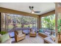 Comfortable screened-in patio with ceiling fan and plush seating, perfect for relaxing outdoors at 12710 Coastal Breeze Way, Bradenton, FL 34211