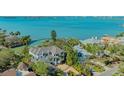 Waterfront home showcasing its beautiful location with direct water access, tropical landscaping and neighborhood at 1540 Hillview Dr, Sarasota, FL 34239