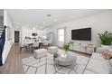 Bright living room with open floor plan connected to modern kitchen and dining area at 164 Eagleston Ln, Sarasota, FL 34240