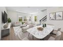 Open-concept living space with bright, natural light, stylish decor, and staircase at 164 Eagleston Ln, Sarasota, FL 34240