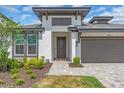 Inviting single-Gathering home featuring a two-car garage and charming landscaping at 17502 Savory Mist Cir, Bradenton, FL 34211