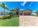 Charming home with a three-car garage, manicured lawn, beautiful landscaping, and a paver driveway. Great curb appeal! at 19921 Petrino St, Venice, FL 34293