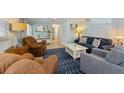 Cozy living room featuring comfortable seating, a TV, and a stylish area rug at 214 Palm Ave, Anna Maria, FL 34216