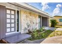 Inviting front entrance with a modern door design and stone accents at 22209 Breezeswept Ave, Port Charlotte, FL 33952