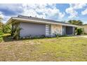 Well-kept single story home featuring wood paneling and xeriscaping at 22209 Breezeswept Ave, Port Charlotte, FL 33952